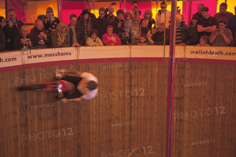 Wall of death motorcycle fairground attraction on Madeira Drive during motorbike festival.