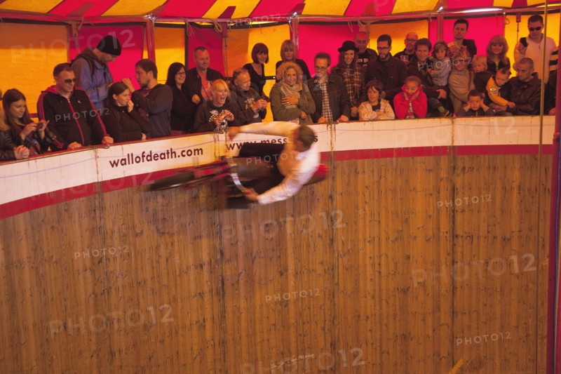 Wall of death motorcycle fairground attraction on Madeira Drive during motorbike festival.