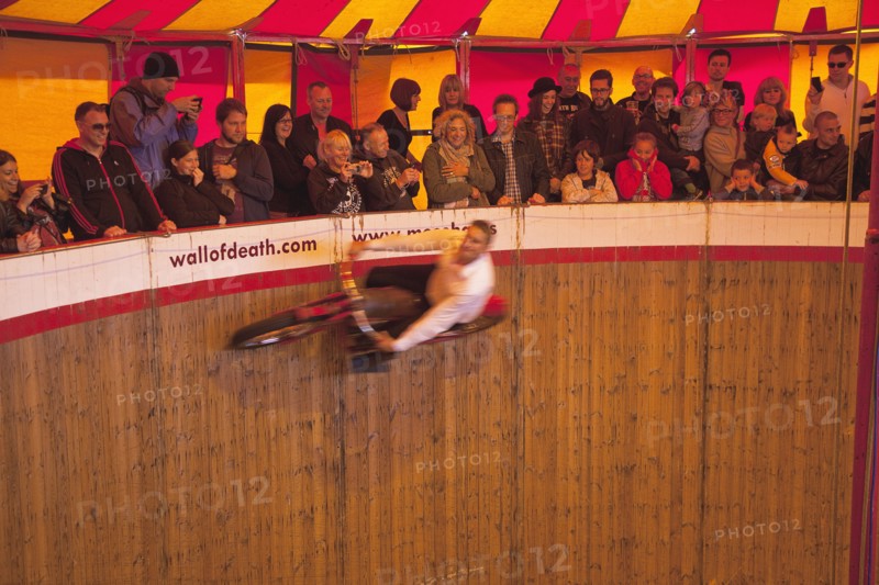 Wall of death motorcycle fairground attraction on Madeira Drive during motorbike festival.