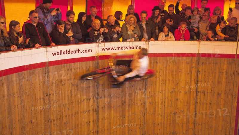 Wall of death motorcycle fairground attraction on Madeira Drive during motorbike festival.