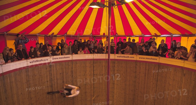 Wall of death motorcycle fairground attraction on Madeira Drive during motorbike festival.