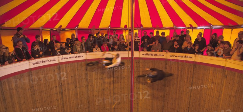 Wall of death motorcycle fairground attraction on Madeira Drive during motorbike festival.