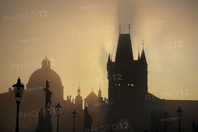 The Calvary statue in early morning mist on Charles Bridge