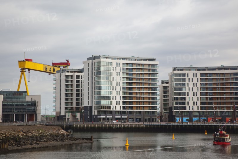 Titanic Quarter Modern apartment blocks on the site of the Harland & Wolff shipyard with sightseeing cruise boat.