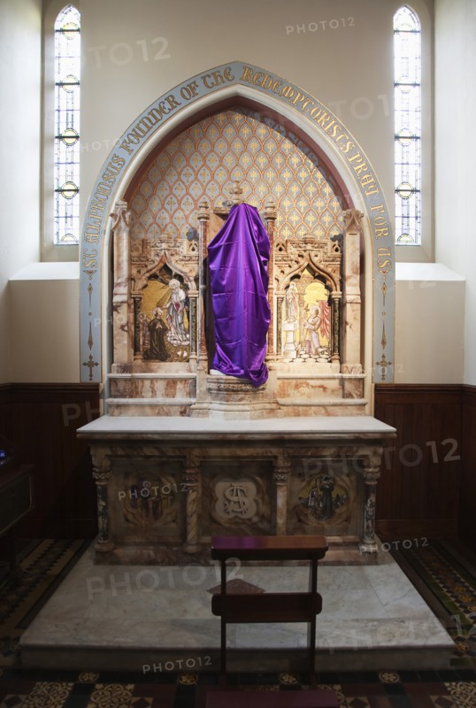 Falls Road Clonard Monastery interior decorated for Good Friday with statues draped in purple cloth.