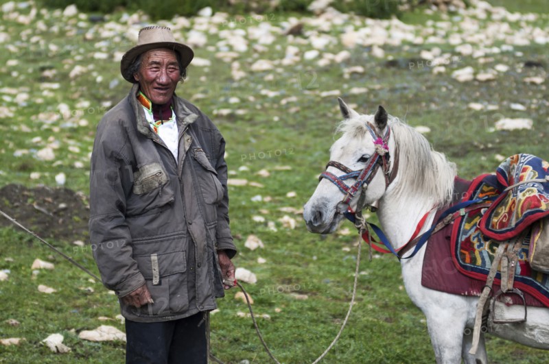 The portrait of a Nepalese high mountain nomad and his horse.