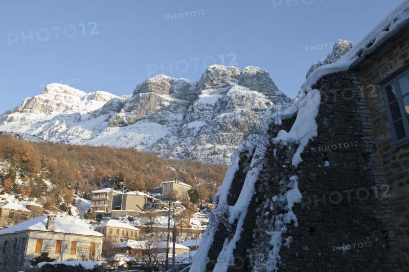 View of the small traditional Greek village Mikro Papigko or Little Papigko built underneath the mountain.
