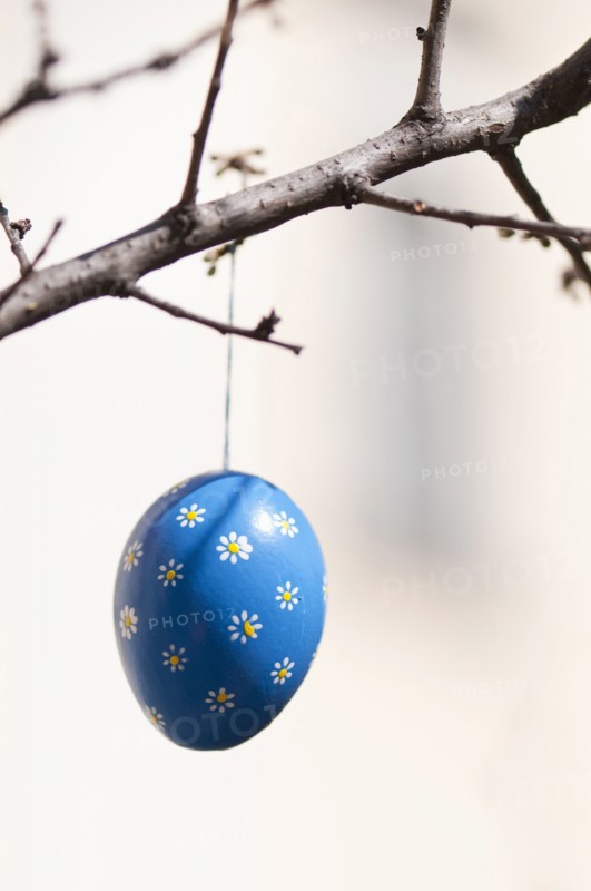 Hand-painted egg shell hanging from a branch to celebrate Easter at the Old Vienna Easter Market at the Freyung.