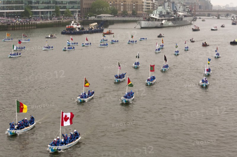Flotilla of Sea Cadets in small boats proceeds along River Thames past HMS Belfast as part of the Queens Thames Diamond Jubilee Pageant taken from Tower Bridge 3rd June 2012.