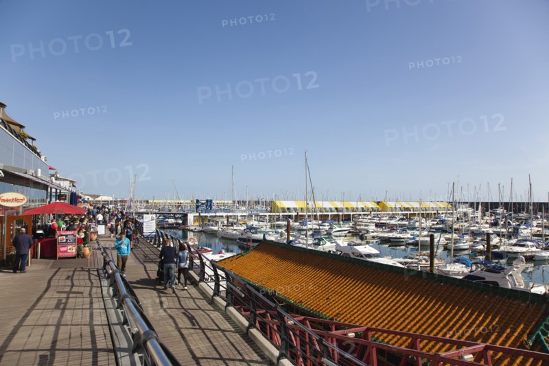 View along the boardwalk over boats moored in the Marina.