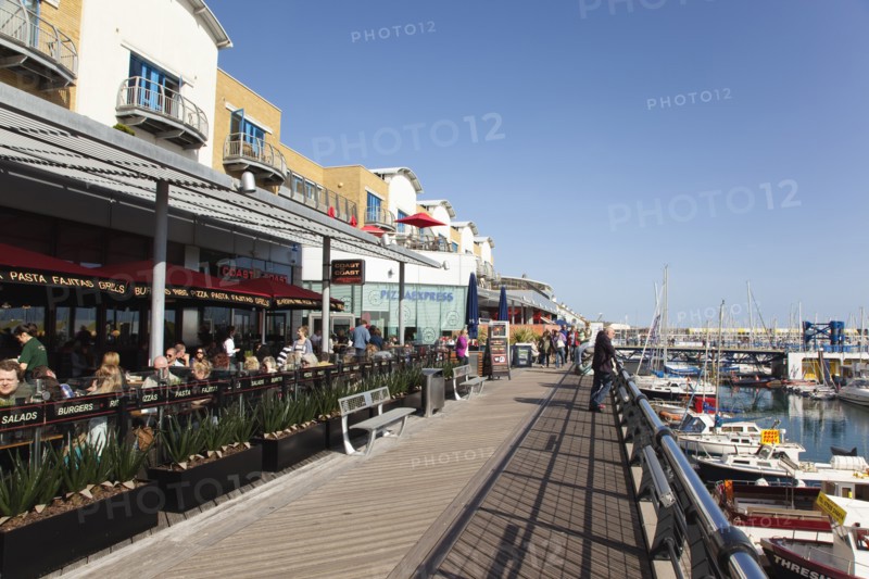 View along the boardwalk over boats moored in the Marina.