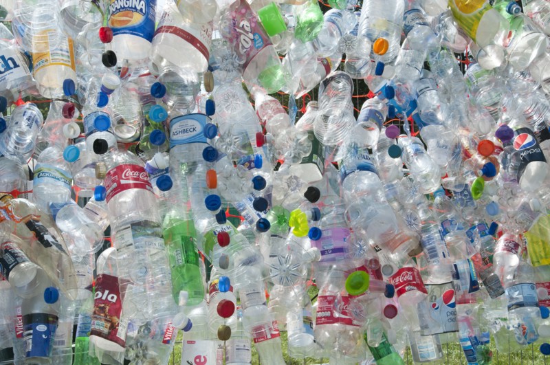 Plastic bottles attached to a wire fence at the WOMAD festival to highlight the need to recycle non-sustaninable materials.