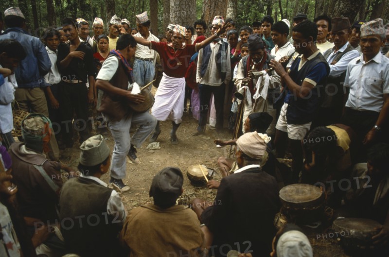 Nepal, Festivals, Male musicians and dancers at Dasain Mela festival in the woods. Photo : Liba Taylor