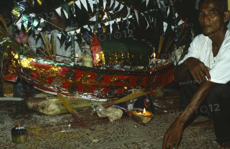 Cambodia, General, Acar or shaman with ritual model boat.Cambodia Shaman or Acar with ritual model boat. Photo : Jonathan Hope