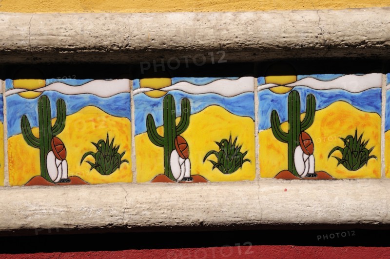 Mexico, Bajio, San Miguel de Allende, Detail of colourful tile depicting figure in Mexican hat sitting at foot of cactus. Photo : Nick Bonetti