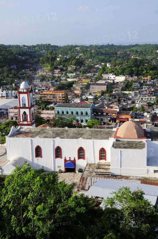 Mexico, Veracruz, Papantla, Views over Cathedral Zocalo and surrounding buildings set amongst trees. Photo : Nick Bonetti