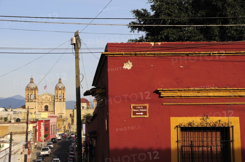 Mexico, Oaxaca, View towards church of Santo Domingo from street corner and red and ochre painted building. Photo : Nick Bonetti