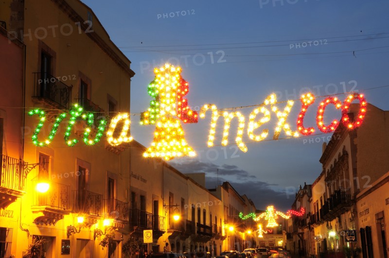 Mexico, Bajio, Zacatecas, Coloured lights hung across street for Independence Day celebrations. Photo : Nick Bonetti