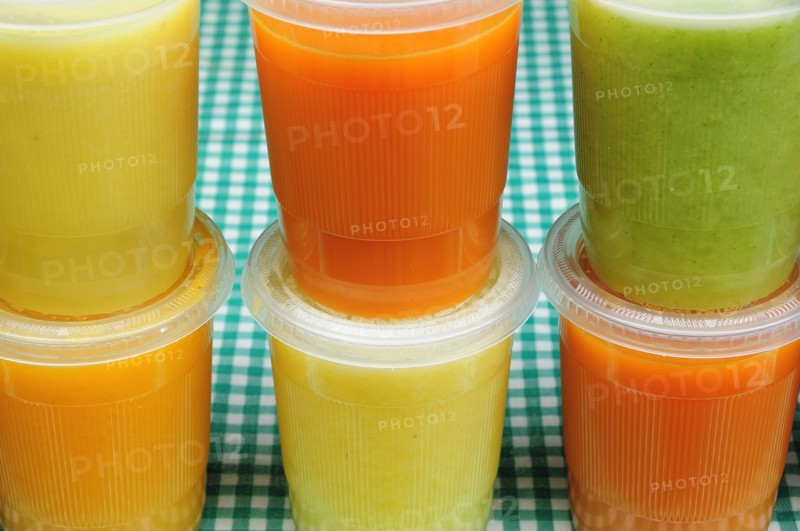 Mexico, Bajio, Guanajauto, Yellow green and orange jugos or fruit juices. Photo : Nick Bonetti