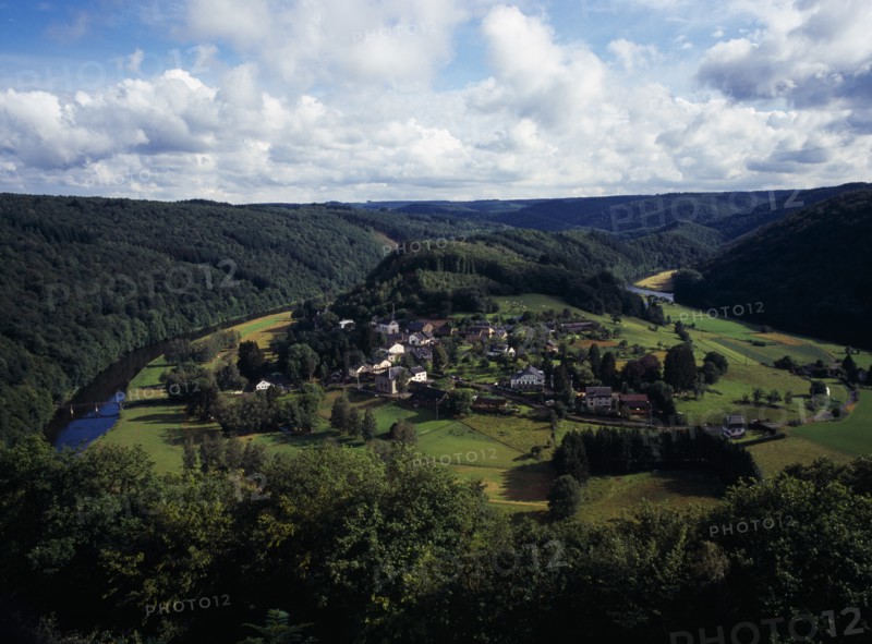 Belgium, Luxembourg, Frahan, View from Rochehaut over village beside the River Semois surrounded by hillsides covered by forest. Photo : Bryan Pickering