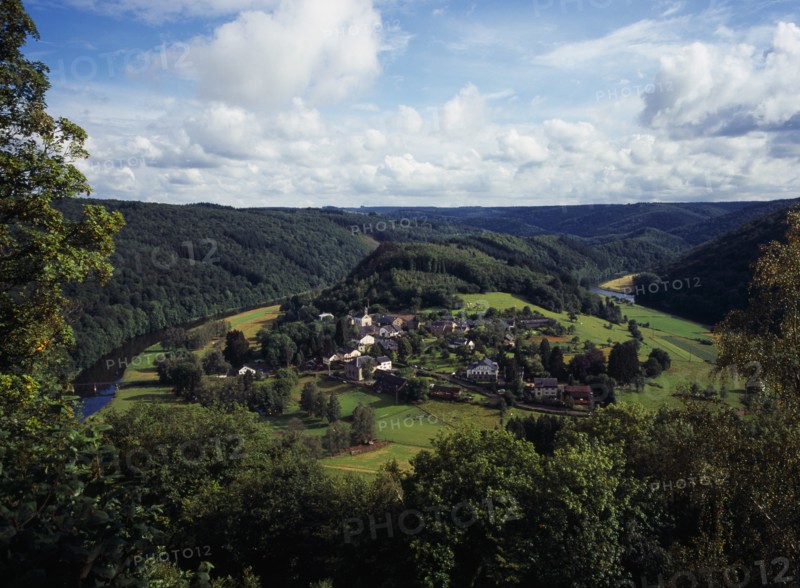 Belgium, Luxembourg, Frahan, View from Rochehaut over village beside the River Semois surrounded by hillsides covered by forest. Photo : Bryan Pickering