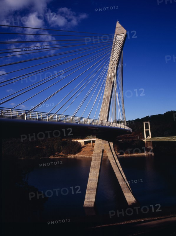 France, Bretagne, Finistere, Low viewpoint from South Bank right hand side looking up at the Pont de Terenez suspension bridge over the River Aulne completed in 2011.. Photo : Bryan Pickering