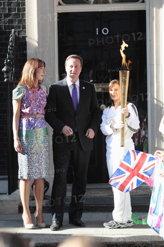 England, London, Olympic Torch relay in Downing Street Samantha and Prime Minister David Cameron welcome the torch. Photo : Sean Aidan
