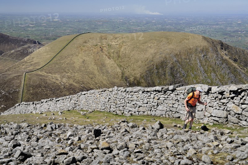 Ireland, County Down, Mourne Mountains, Hiker on Slieve Donard with Slieve Commedagh behind. Photo : Hugh Rooney