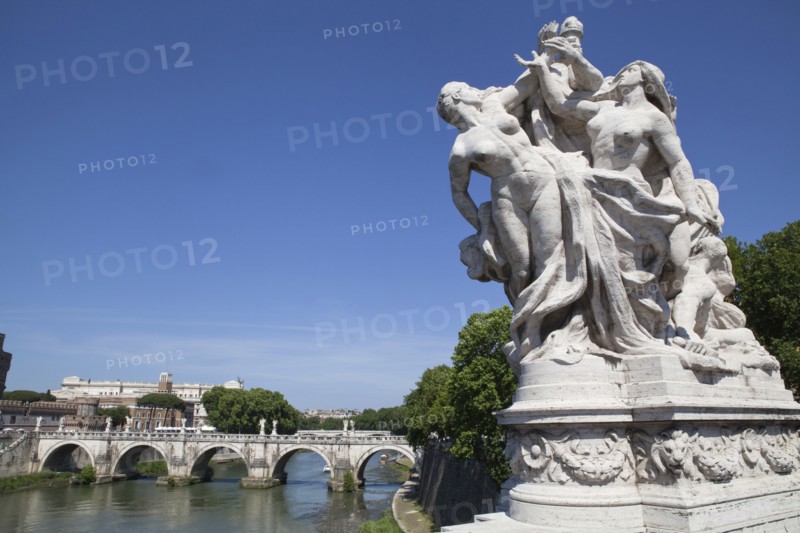 Italy, Lazio, Rome, Statue on the Ponte Vittorio Emanuele with Castel Sant Angelo in the background. Photo : Bennett Dean