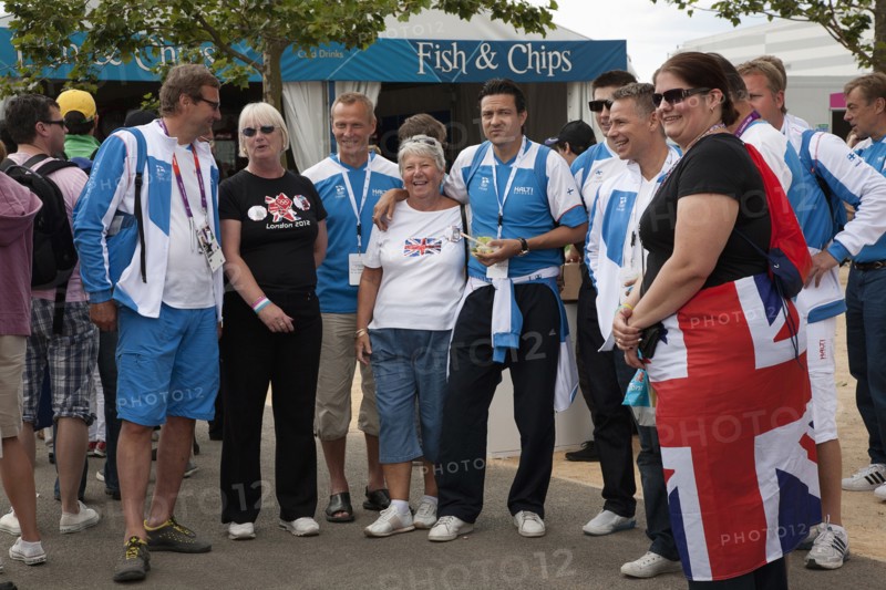 England, London, Stratford Olympic Park Group of Team GB supporters having their photographs taken with competitors from Finland. Photo : Adina Tovy - Amsel