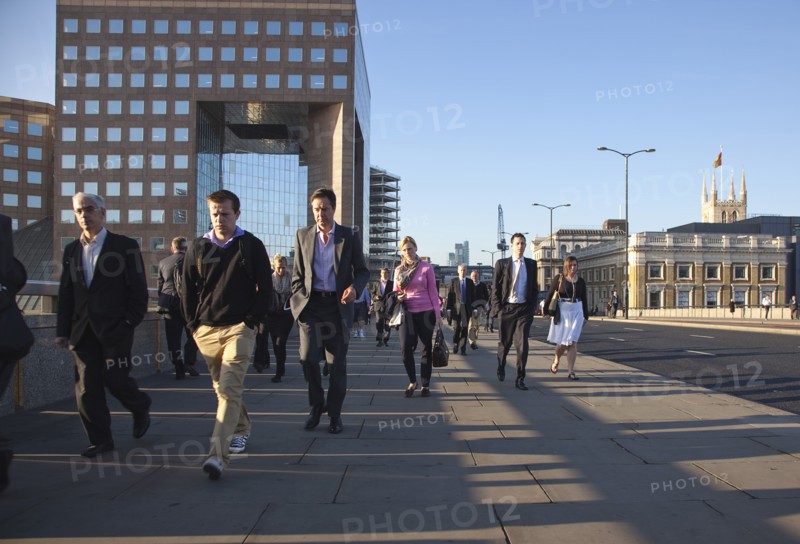 England, London, Early morning commuters crossing London Bridge towards the City Financial district. Photo : Stephen Rafferty