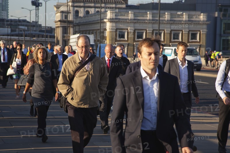 England, London, Early morning commuters crossing London Bridge towards the City Financial district. Photo : Stephen Rafferty