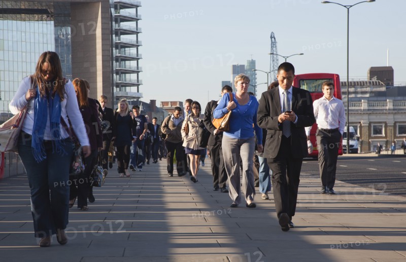 England, London, Early morning commuters crossing London Bridge towards the City Financial district. Photo : Stephen Rafferty