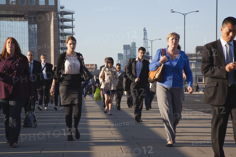 England, London, Early morning commuters crossing London Bridge towards the City Financial district. Photo : Stephen Rafferty