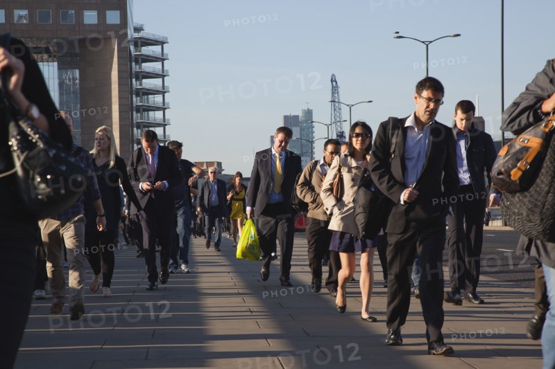 England, London, Early morning commuters crossing London Bridge towards the City Financial district. Photo : Stephen Rafferty