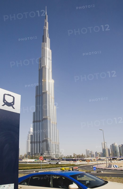 UAE, Dubai, Metro sign and taxi in front of Burj Khalifa tower. 
Photo John Dakers / Eye Ubiquitous