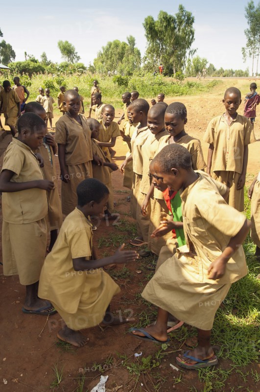 Burundi, Cibitoke Province, Buganda, Ruhagurika Primary School girls dancing during their playtime outside Catch-Up Class in Buganda Commune. Catch up classes were established by Concern Worldwide across a number of schools to provide a second chance for children who had dropped out. 
Photo Nic I Anson / Eye Ubiquitous