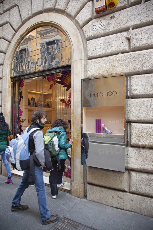 Italy, Lazio, Rome, Via del Condotti Tourists looking at shoe display in the Jimmy Choo shop. 
Photo Stephen Rafferty / Eye Ubiquitous