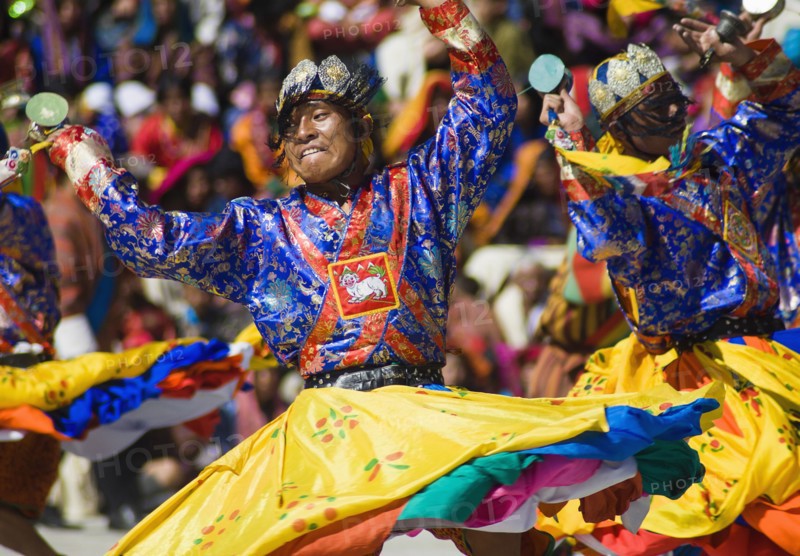 Bhutan, Thimpu Dzong, Dancers in the courtyard during festival. 
Photo Nic I'Anson