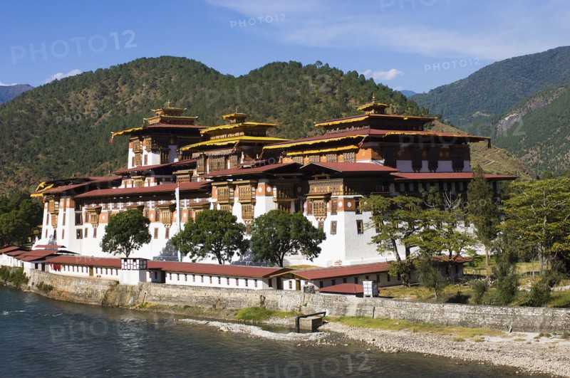Bhutan, Punakha, Punakha Dzong, administrative centre of the region and former capital housing scared relics, beside the Mo Chhu river. 
Photo Nic I'Anson