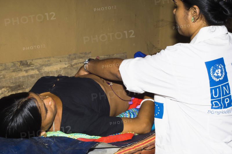 Bangladesh, Chittagong Division, Khagrachari, Pregnant mother being examined by UNDP nurse. 
Photo Nic I'Anson