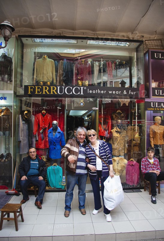 Turkey, Istanbul, Fatih, Sultanahmet, Kapalicarsi, Customer and owner of Ferrucci's Leather Wear and Fur Store in the Grand Bazaar. 
Photo Stephen Rafferty
