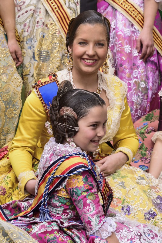 Spain, Valencia Province, Valencia, Reina Fallera in traditional Valencian costume taking a break with young child also in traditional Valencian costume during Las Fallas festival. 
Photo Hugh Rooney