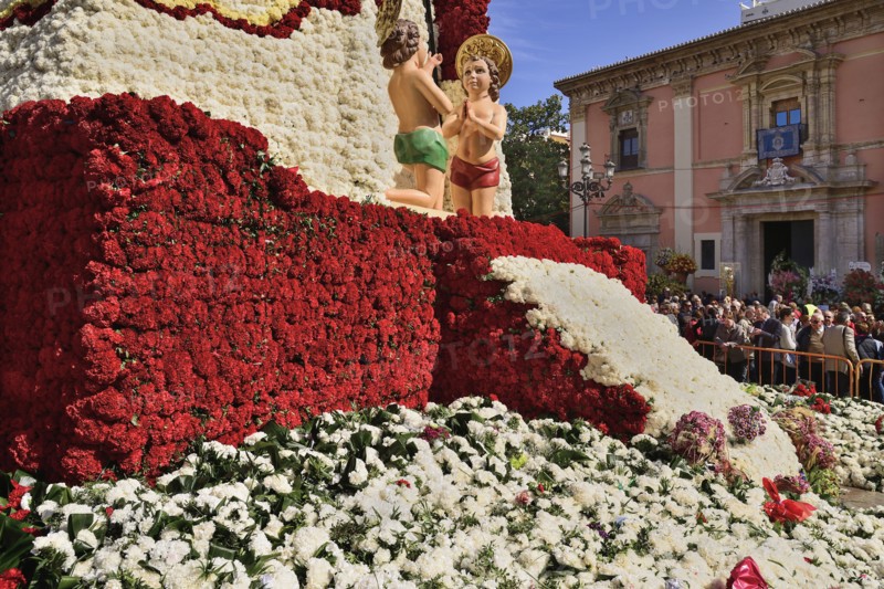 Spain, Valencia Province, Valencia, Base of the Statue of Virgen de los Desamparados, Our Lady of the Forsaken, decked out with flowers carried in the religious procession during Las Fallas festival. 
Photo Hugh Rooney