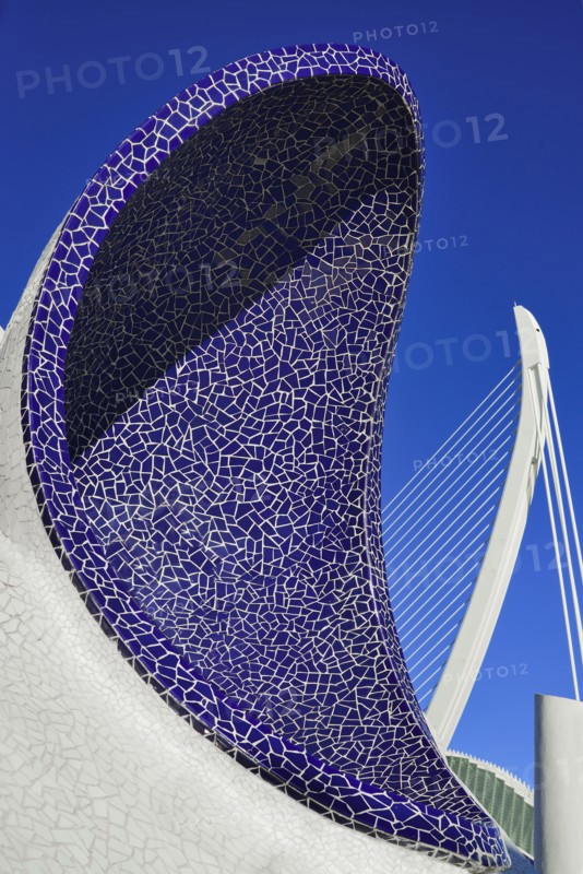 Spain, Valencia Province, Valencia, Spain, Valencia Province, Valencia, La Ciudad de las Artes y las Ciencias, City of Arts and Sciences, An arch of the Umbracle sculpture garden with El Pont de l'Assut de l'Or bridge in the background. 
Photo Hugh Rooney