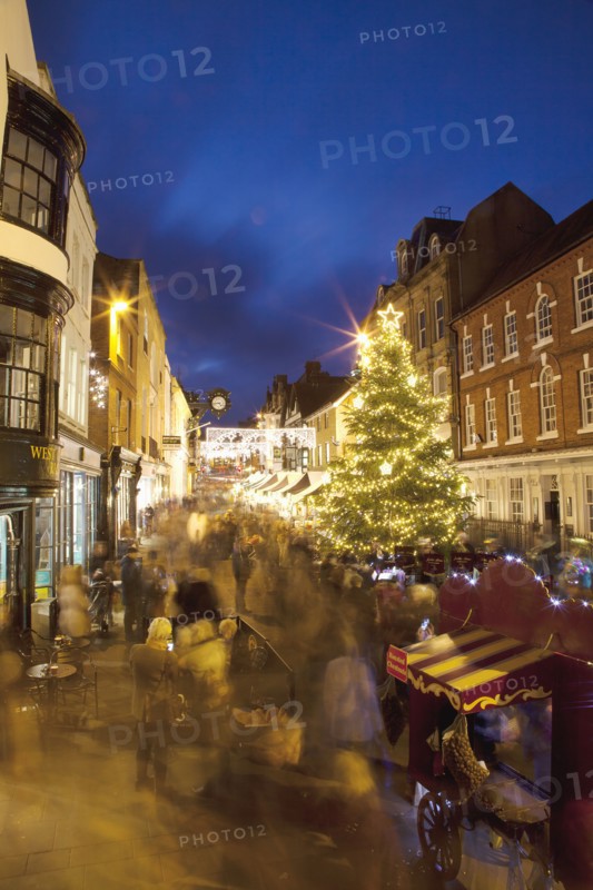 England, Hampshire, Winchester, High street decorated with Christmas tree and decorations, seen from the Buttercross.