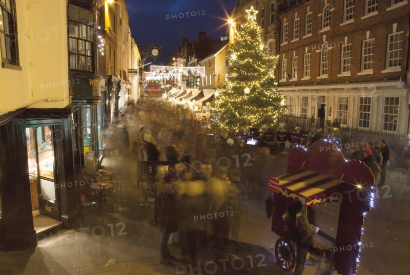 England, Hampshire, Winchester, High street decorated with Christmas tree and decorations, seen from the Buttercross.