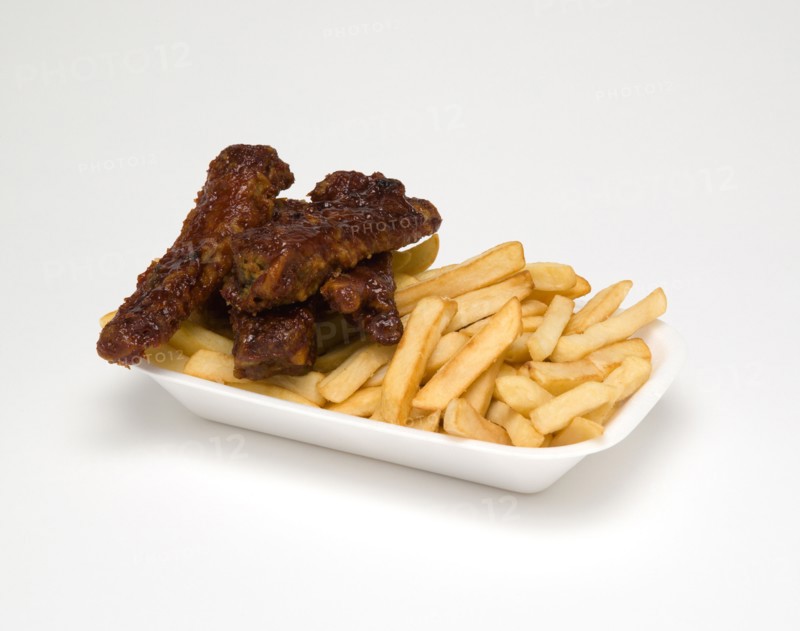 Food, Cooked, Meat, Sticky pork ribs with potato chips in a polystyrene foam tray on a white background.