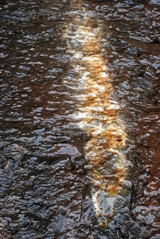Detail of running water on a rock