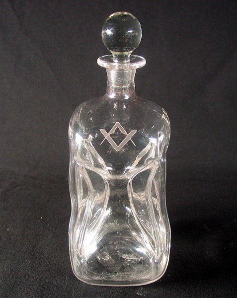 Pinched decanter with square and compasses.